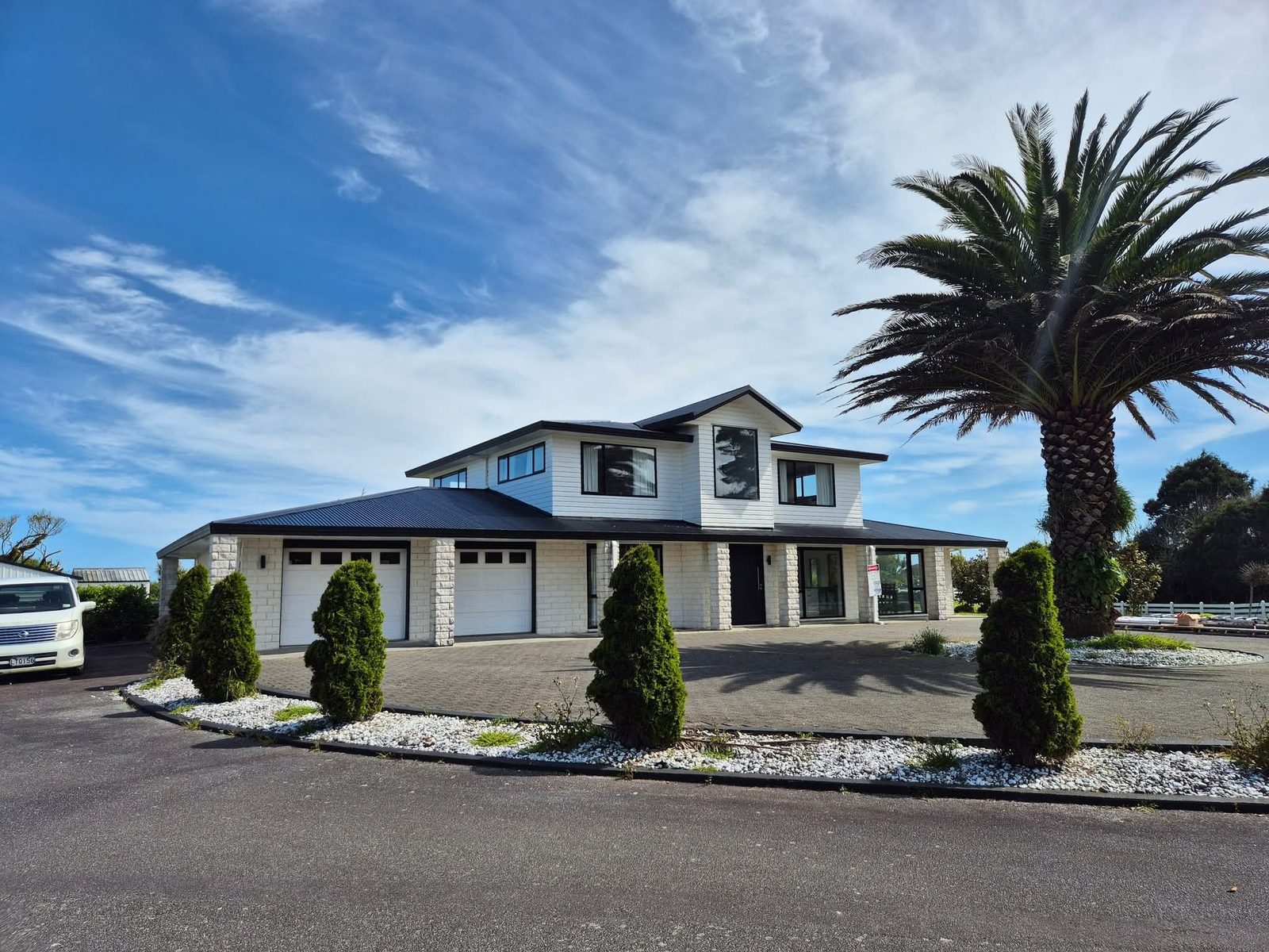 New build home with dark long-run steel roof by Up Top Roofing